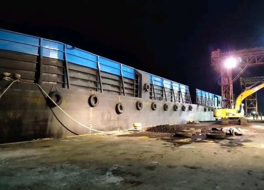 Barge alongside terminal during night operation