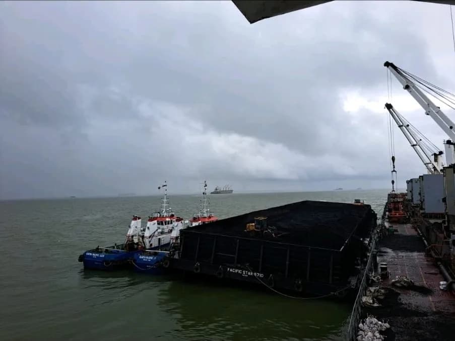 Loaded barge with tug support at sea