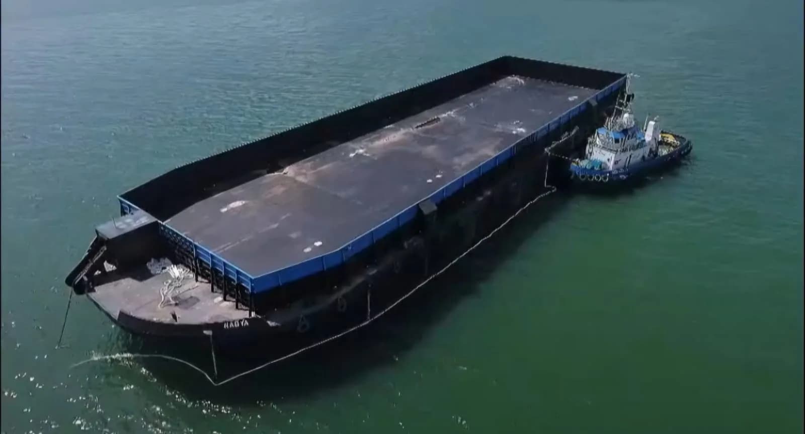 Tug boat alongside barge